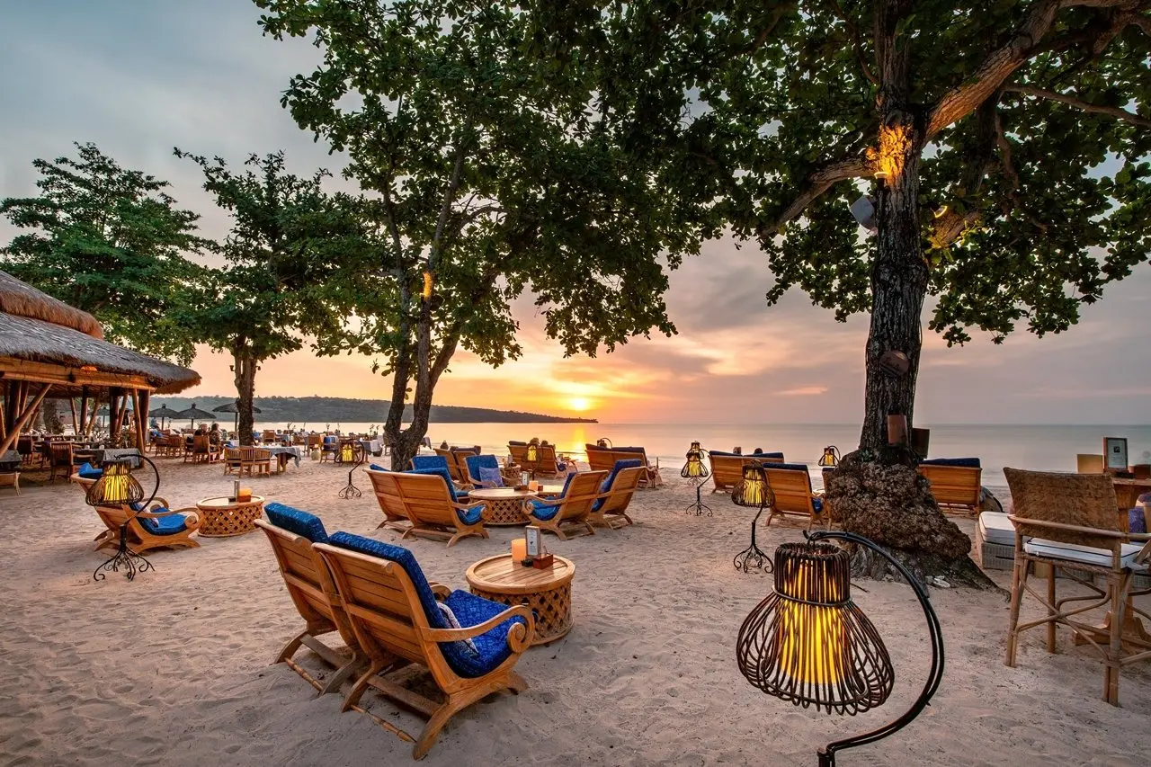 Beachfront outdoor lounge terrace at sunset